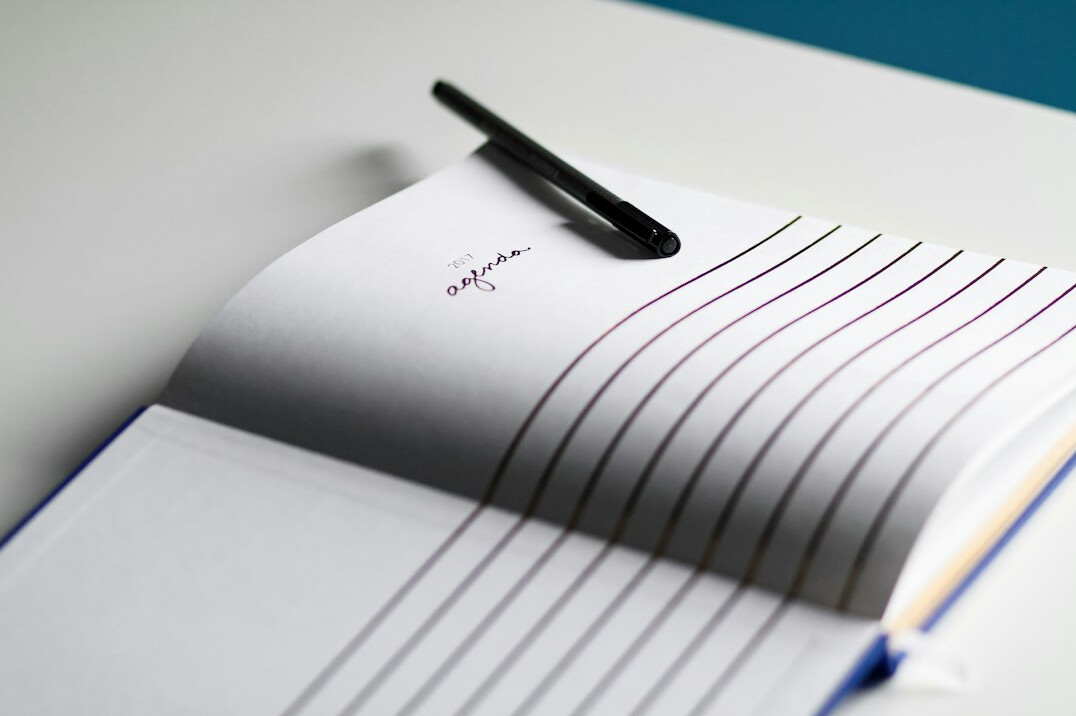 Notebook with argumentation diagrams and a pen